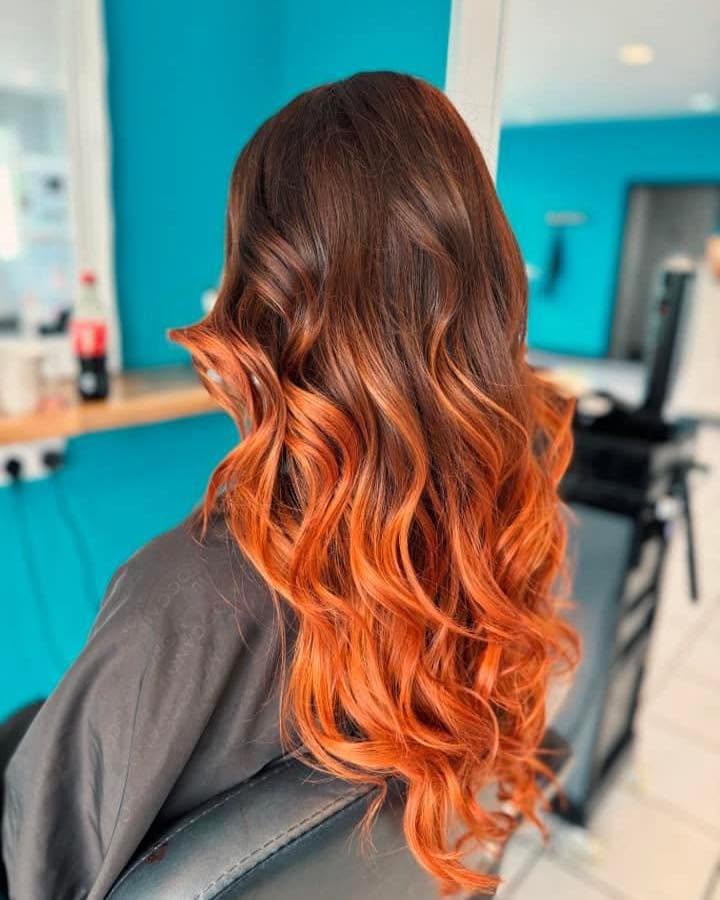 Rich copper balayage transformation with soft curls