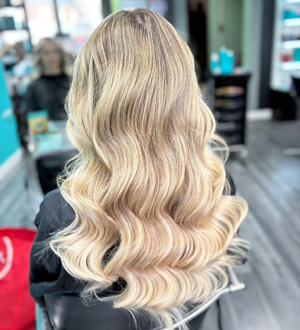 Golden blonde balayage finished with glossy curls